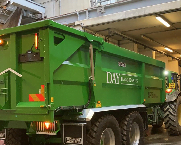 Green Day Aggregates trailer attached to a green john deer tractor