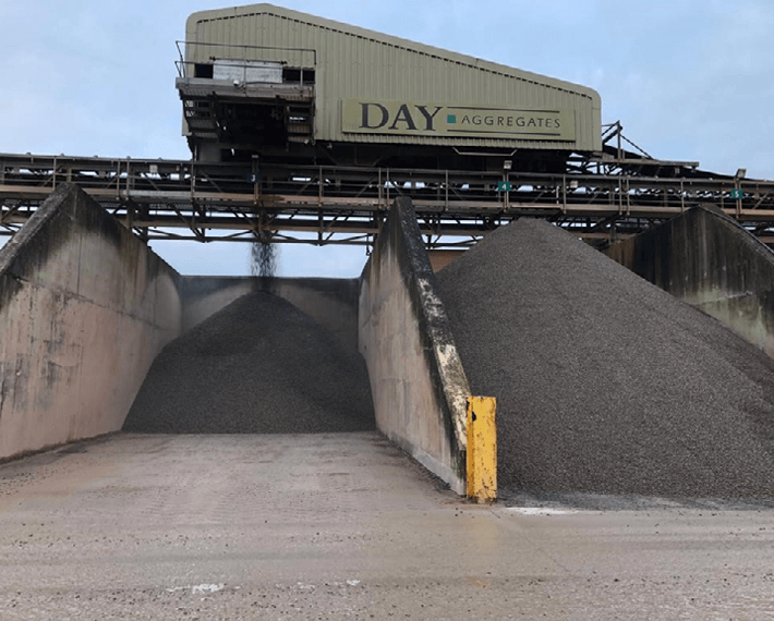 Material bays with a conveyer belt dropping it from above