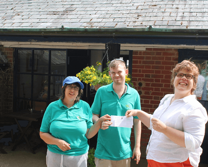 three people holding a certificate