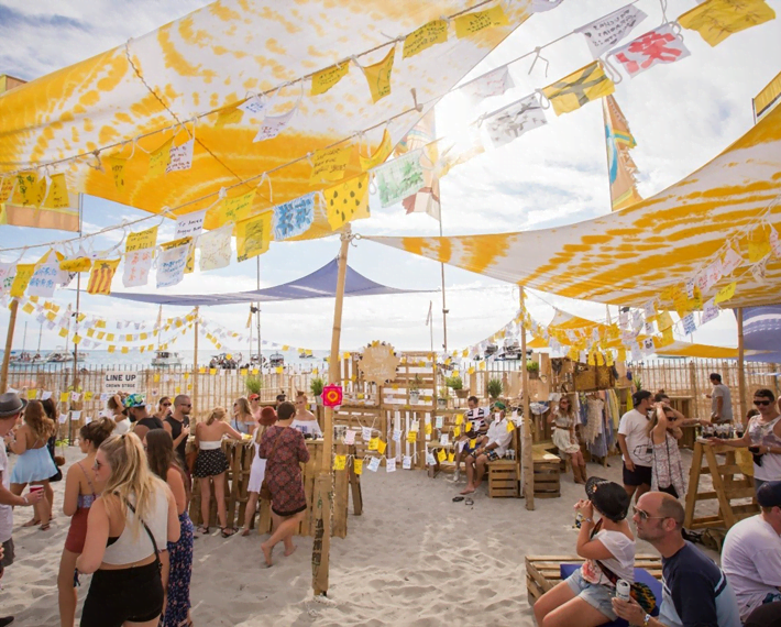 Groups of people on the beach at a festival