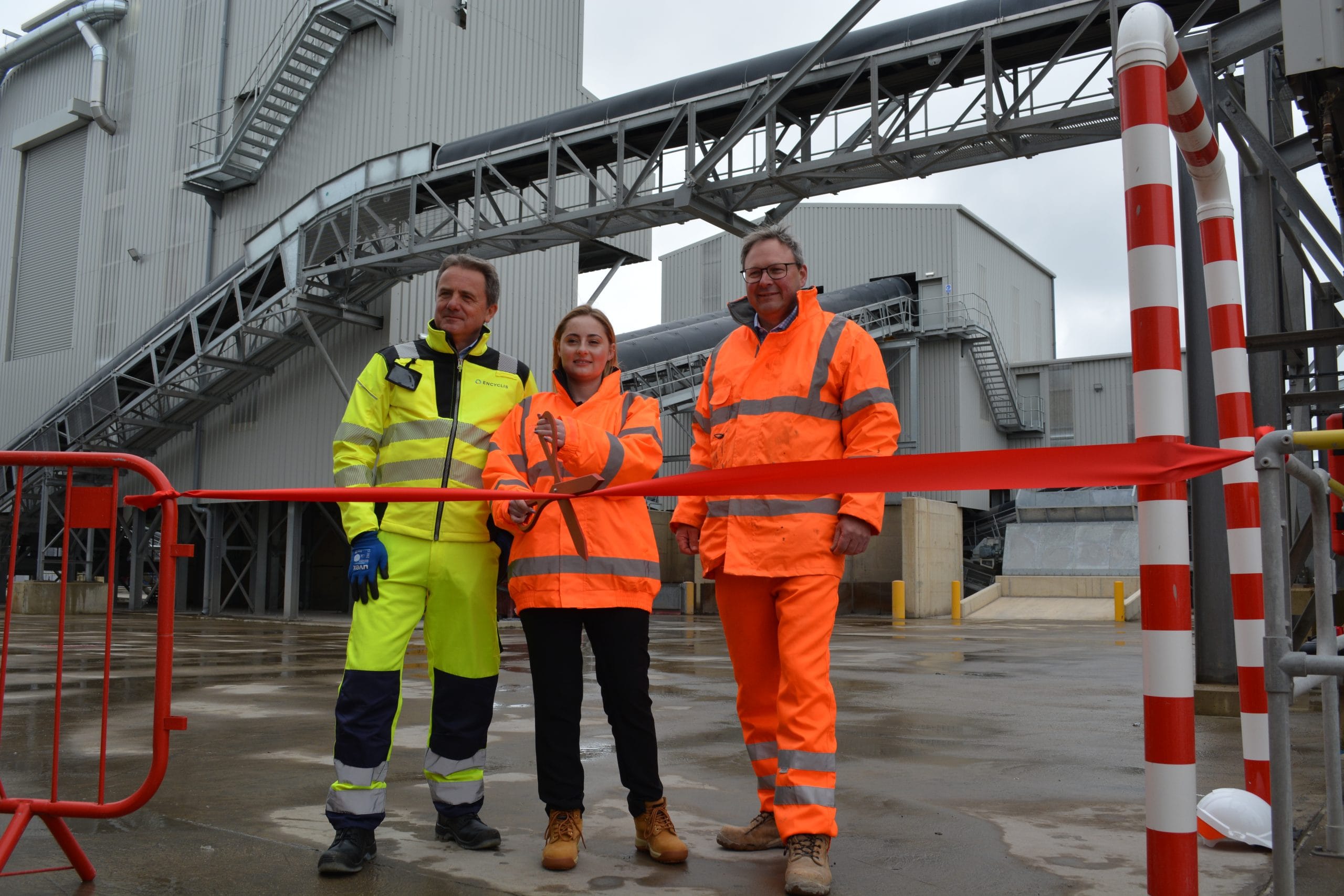 three people in PPE cutting the ribbon to a Day Aggregates plant