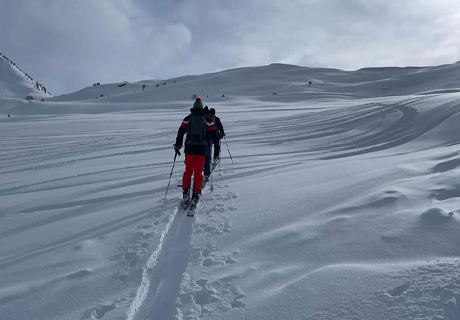 Hikers climbing a mountain in the snow