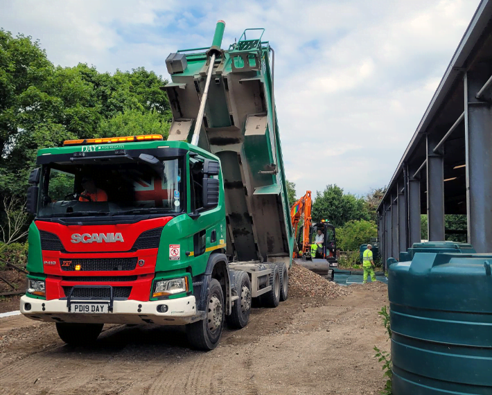 Green and Red Day Aggregates lorry tipping material