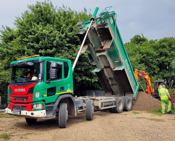 Green and Red Day Aggregates lorry tipping material