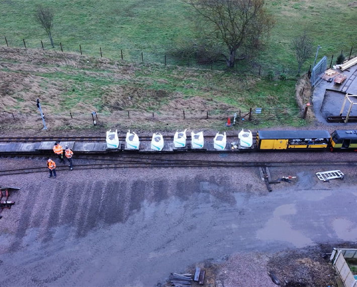 Drone shot of white tonne bags with track ballast in on a railway track